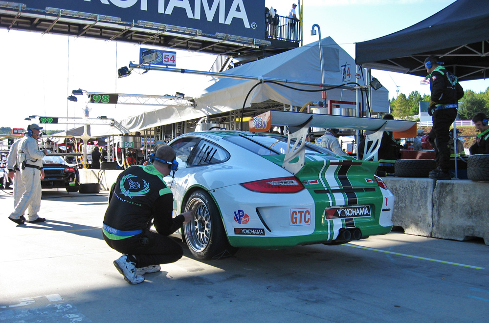 The Black Swan Racing Porsche 911 GT3 cup being worked on in put lane at Road Atlanta.