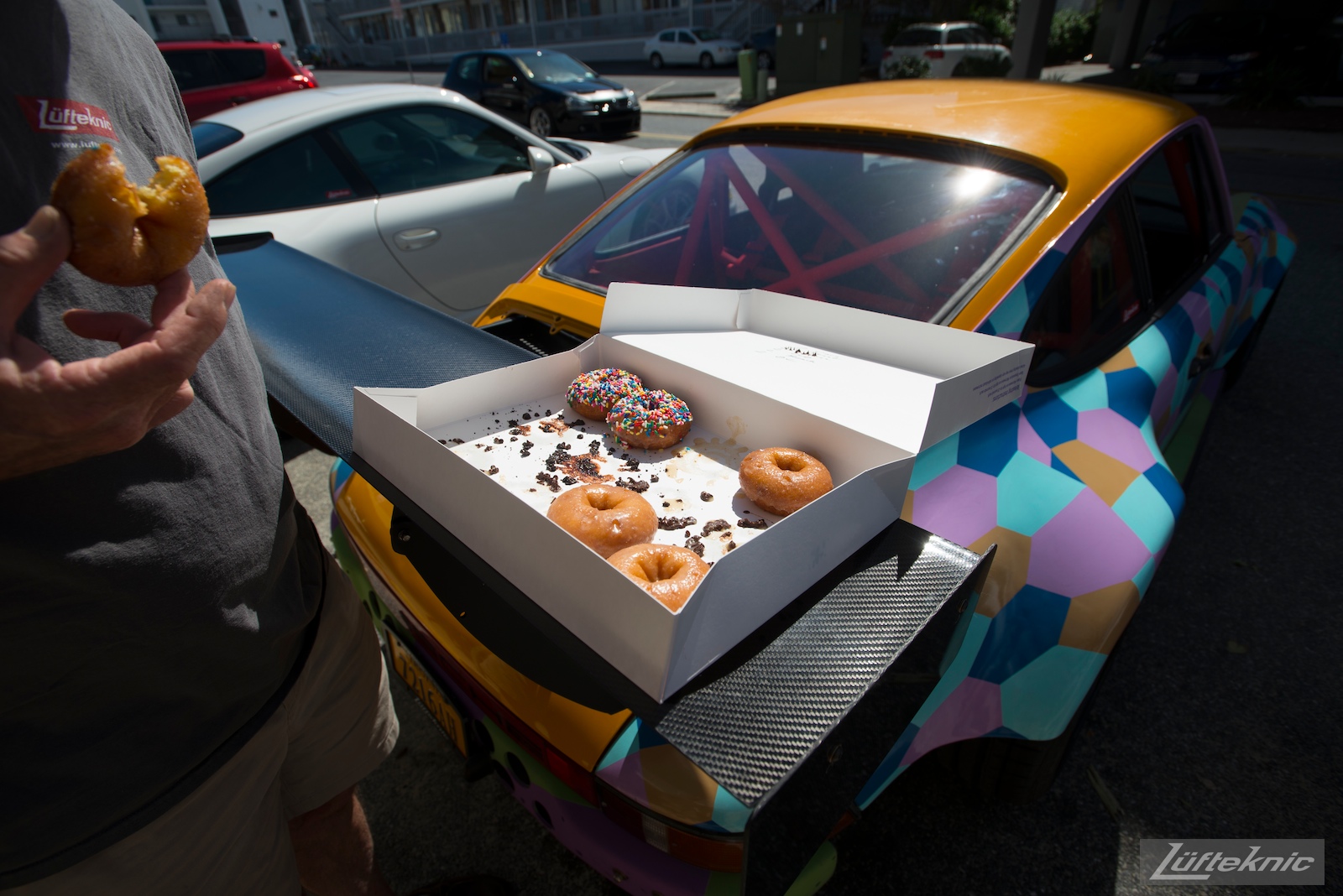 A box of donuts sitting on the raw carbon fiber wing of the Lüfteknic #projectstuka Porsche 930 Turbo