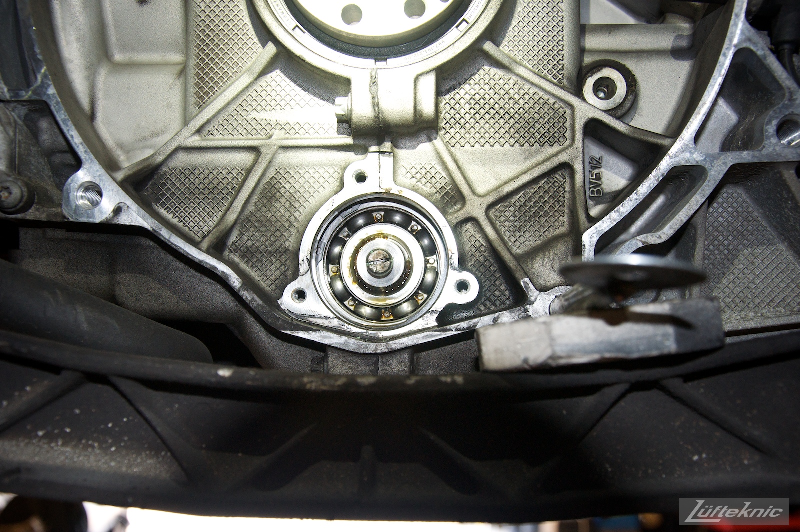 A picture of an M96 996 engine IMS bearing with the seal removed, exposing the bearing cage and bearings.