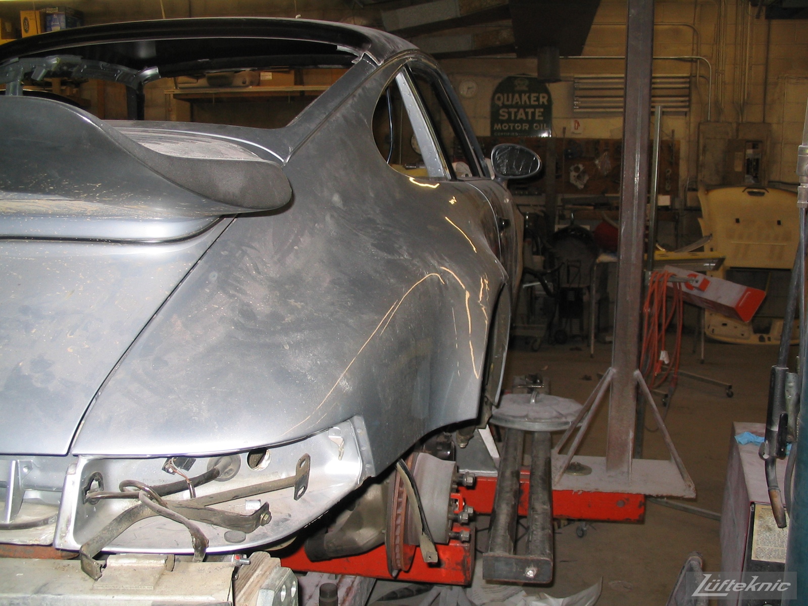 Wrecked Porsche 964 RS America on the frame rack