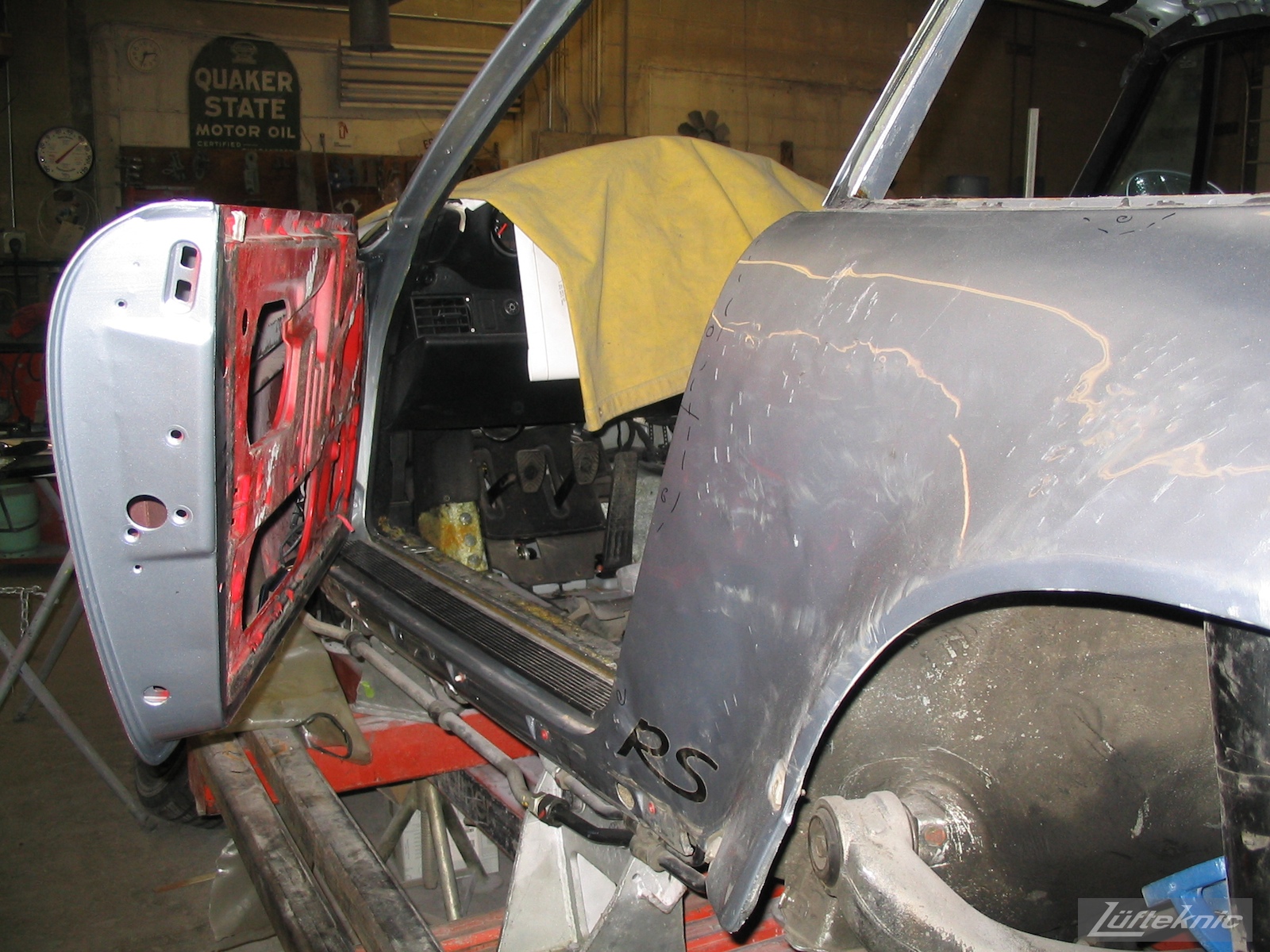 Wrecked Porsche 964 RS America on the frame rack