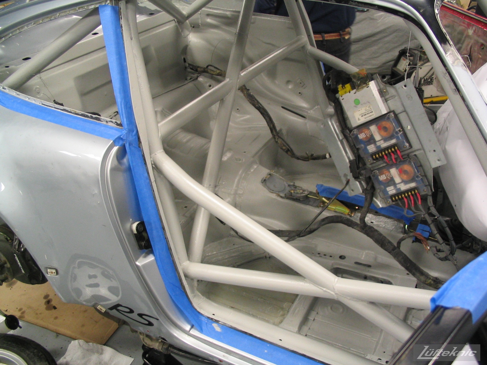 Roll cage has been installed and painted on the 964 RS America project, shown with no seats.