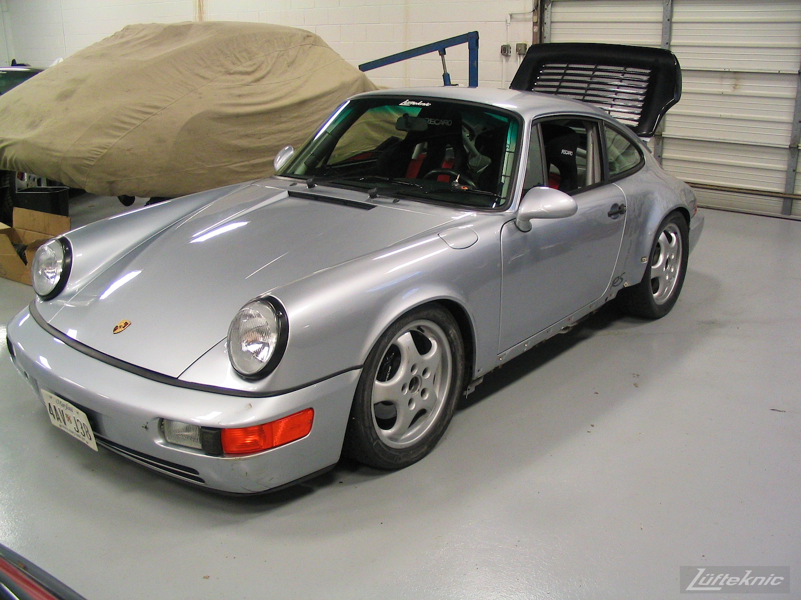 Roll cage, seats, harness installed and fresh paint shown on the 964 RS America.
