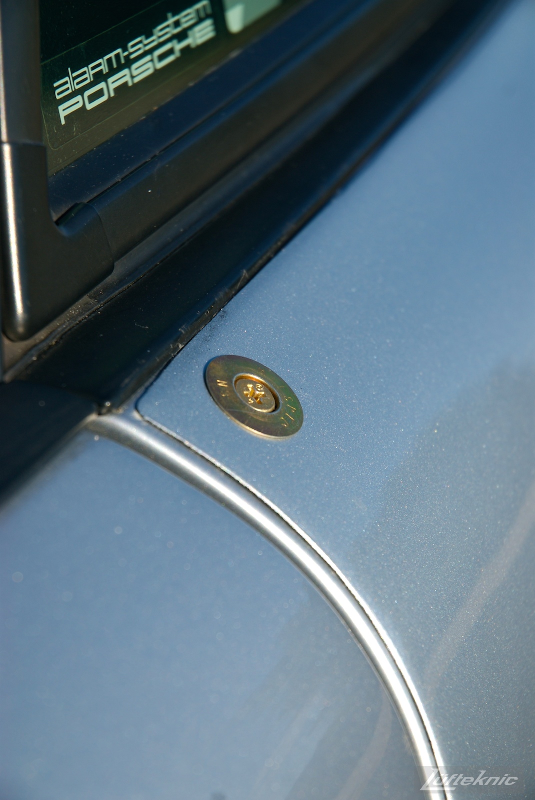 A detailed photo of a cam lock fastener on the side of the RS America.