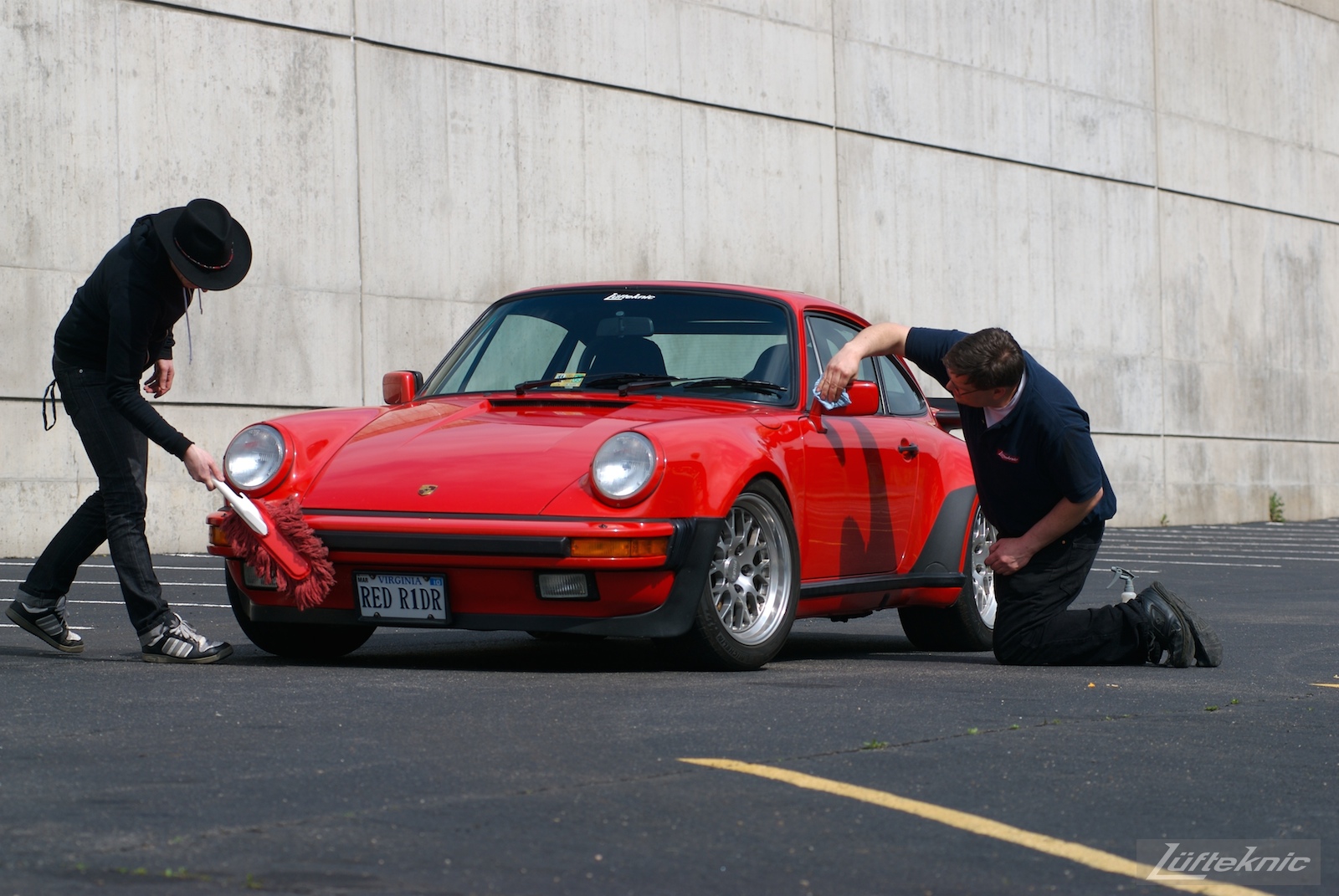 Red Porsche 930 Turbo being detailed.