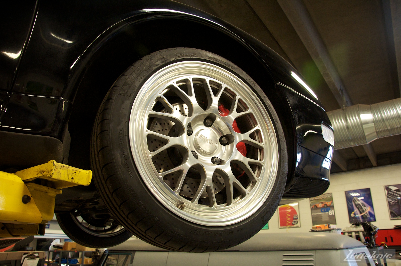 A close up of a Fikse wheel on the front of a 993 Turbo on a lift in the Lufteknic shop.