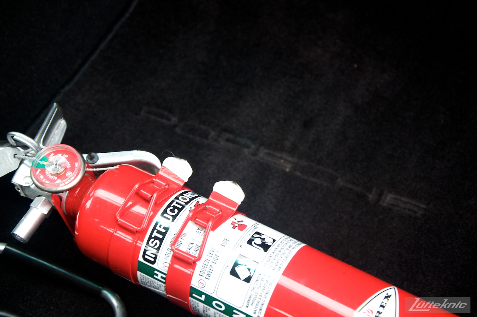 Fire extinguisher shown on a black 993 Turbo GT2 rear wheel drive conversion sits in the Lufteknic parking lot ready for pick up.