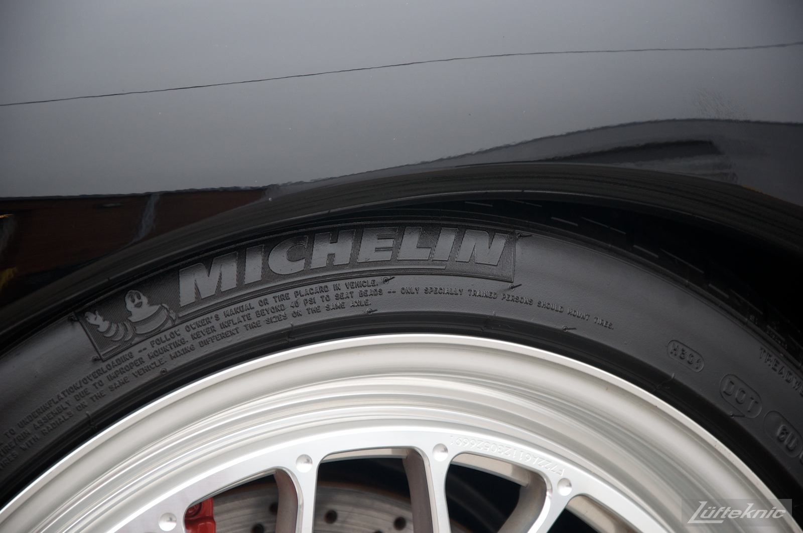 Detail shot of the Michelin Pilot tire and Fikse wheel on a black 993 Porsche Turbo.