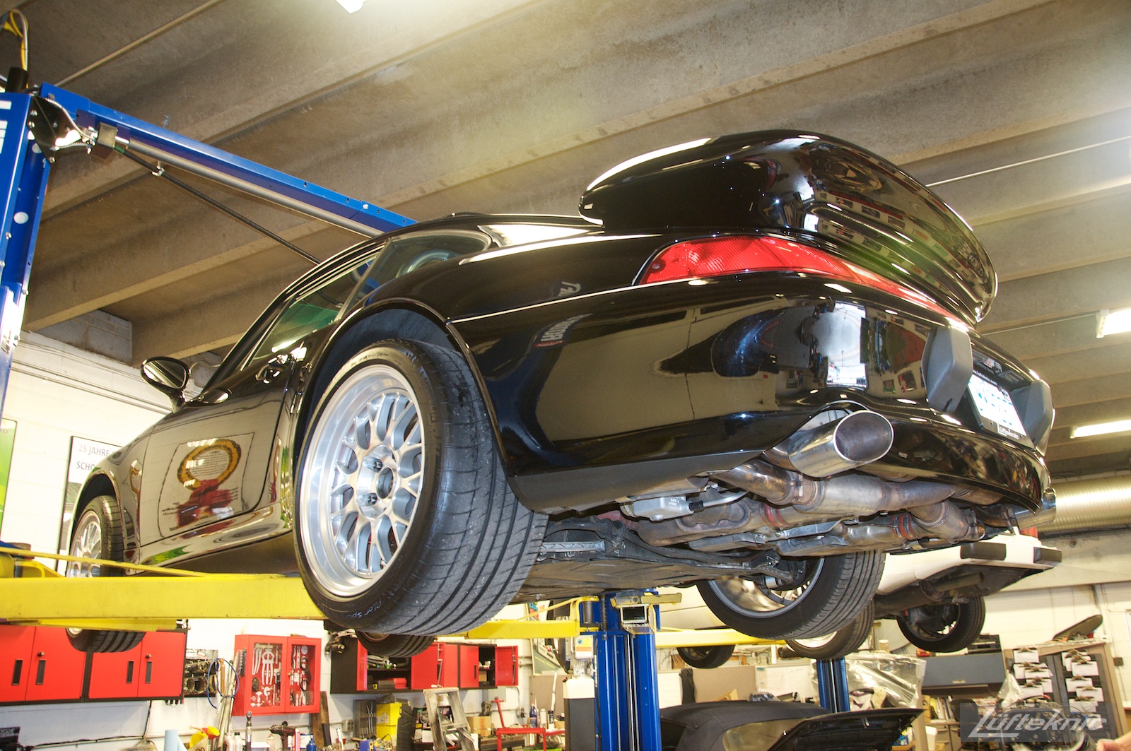 A 993 GT2 turbo conversion sits on a lift.