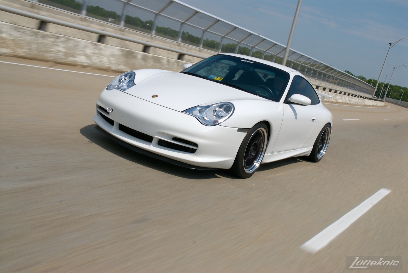 A track-prepped white Porsche 996 Gt3 with Fikse wheels.