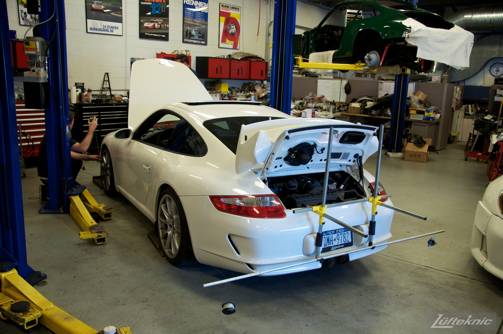 A white 993 GT3 being aligned at the Lufteknic shop.