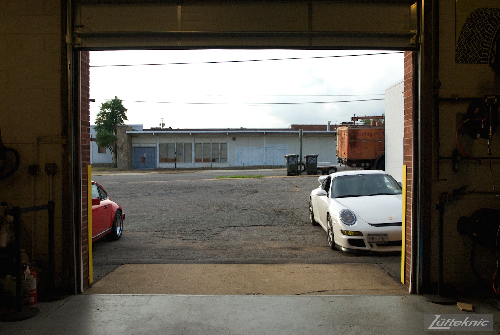 A white 997 GT3 sitting just outside the Lufteknic shop door with other Porsches shown.