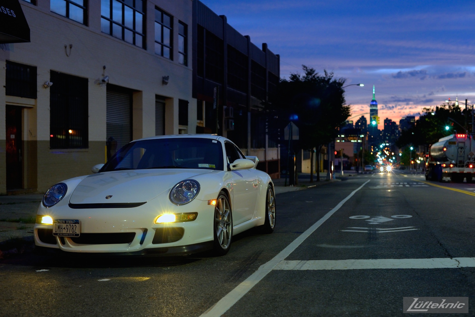 A white 997 GT3 sits on the side of the road in NYC.
