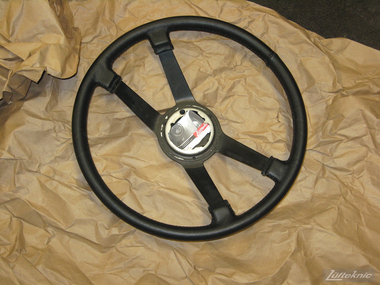 Refinished steering wheel for a 914 sitting on packing paper.