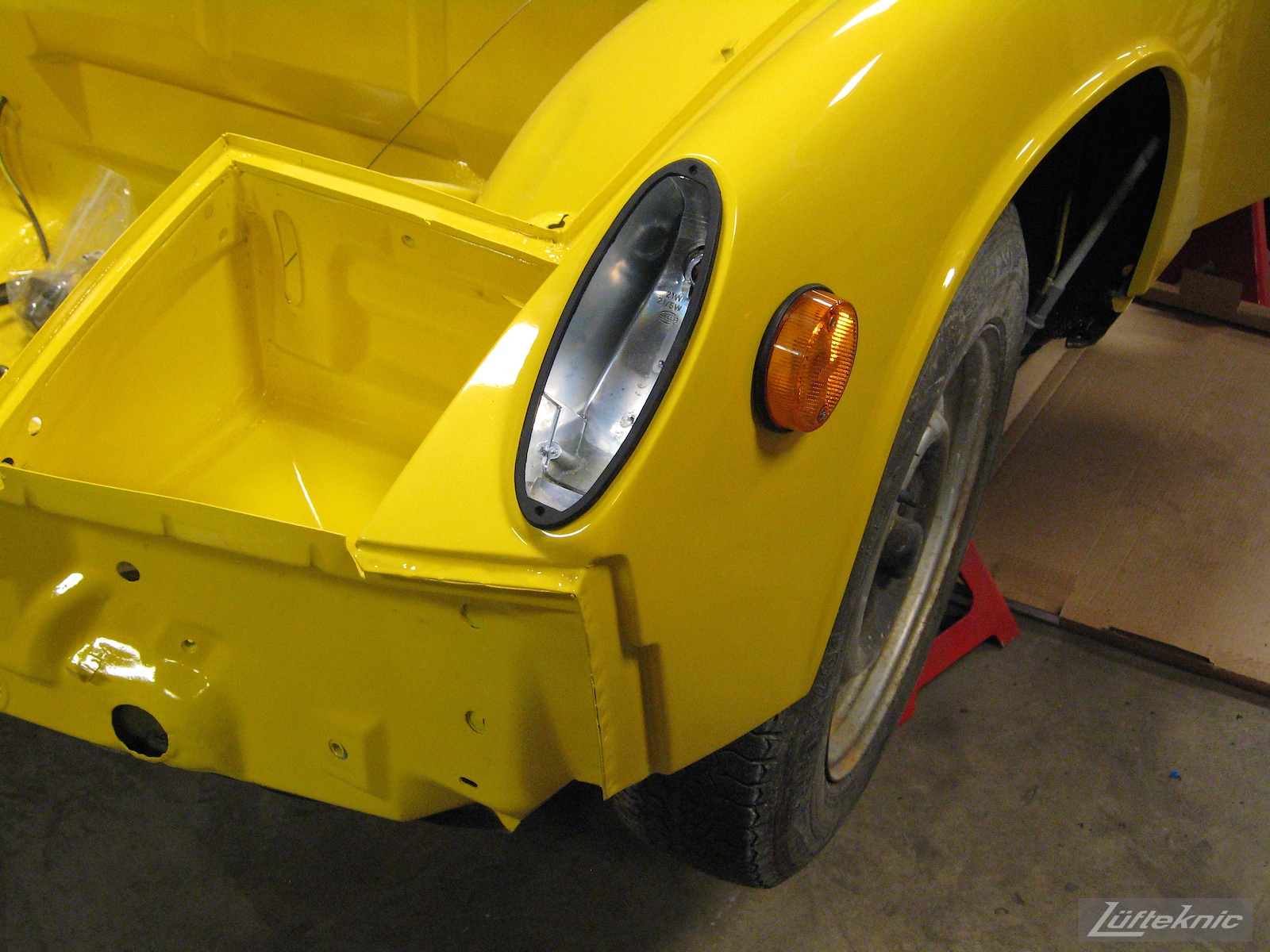 Reassembling a restored yellow Porsche 914 at Lufteknic.