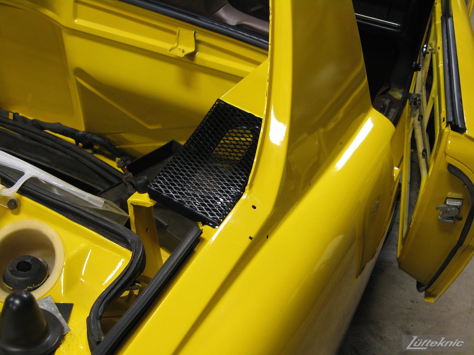 Rear engine decklid cover details on a restored yellow Porsche 914 at Lufteknic.