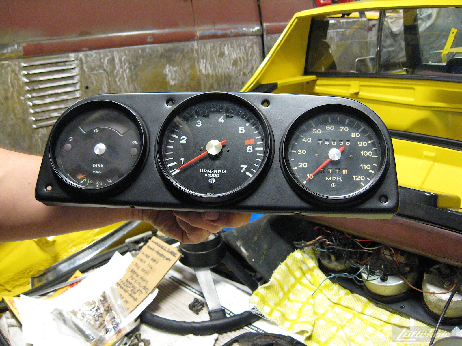 Dashboard and gauges shown for a restored yellow Porsche 914 at Lufteknic.