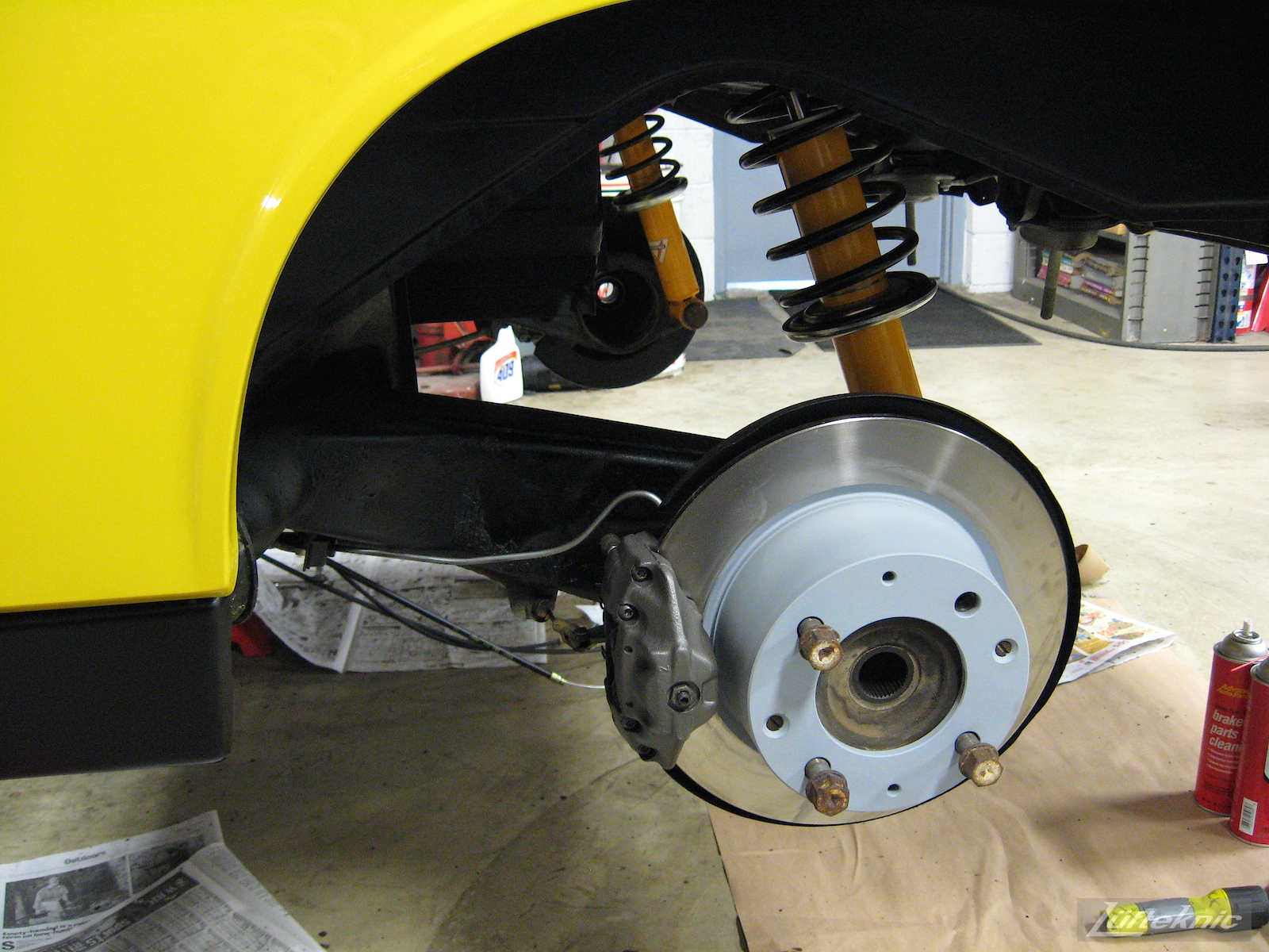 Fresh rear brakes for a restored yellow Porsche 914 at Lufteknic.