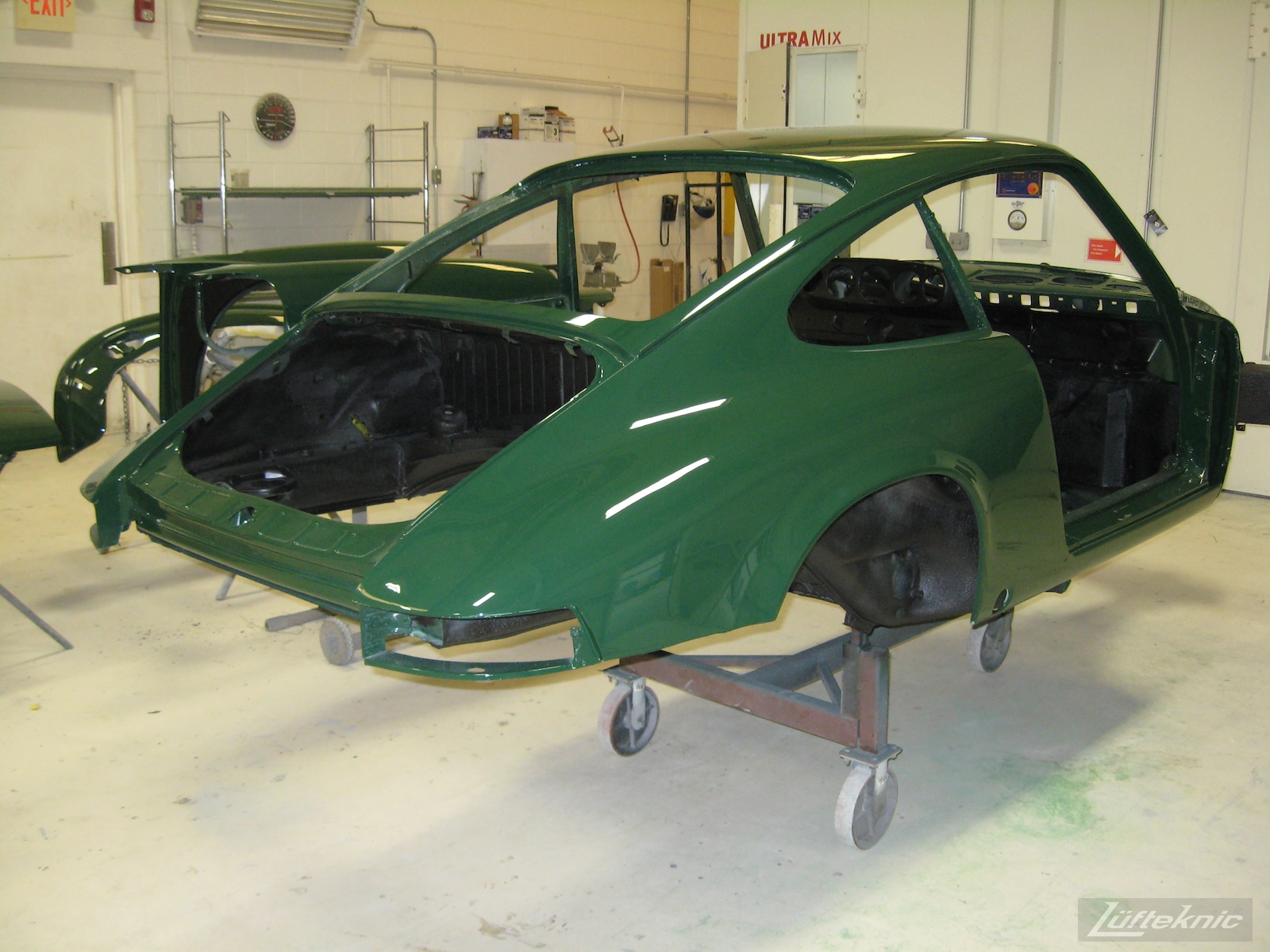 Freshly painted body shell of an Irish Green Porsche 912 undergoing restoration at Lufteknic.