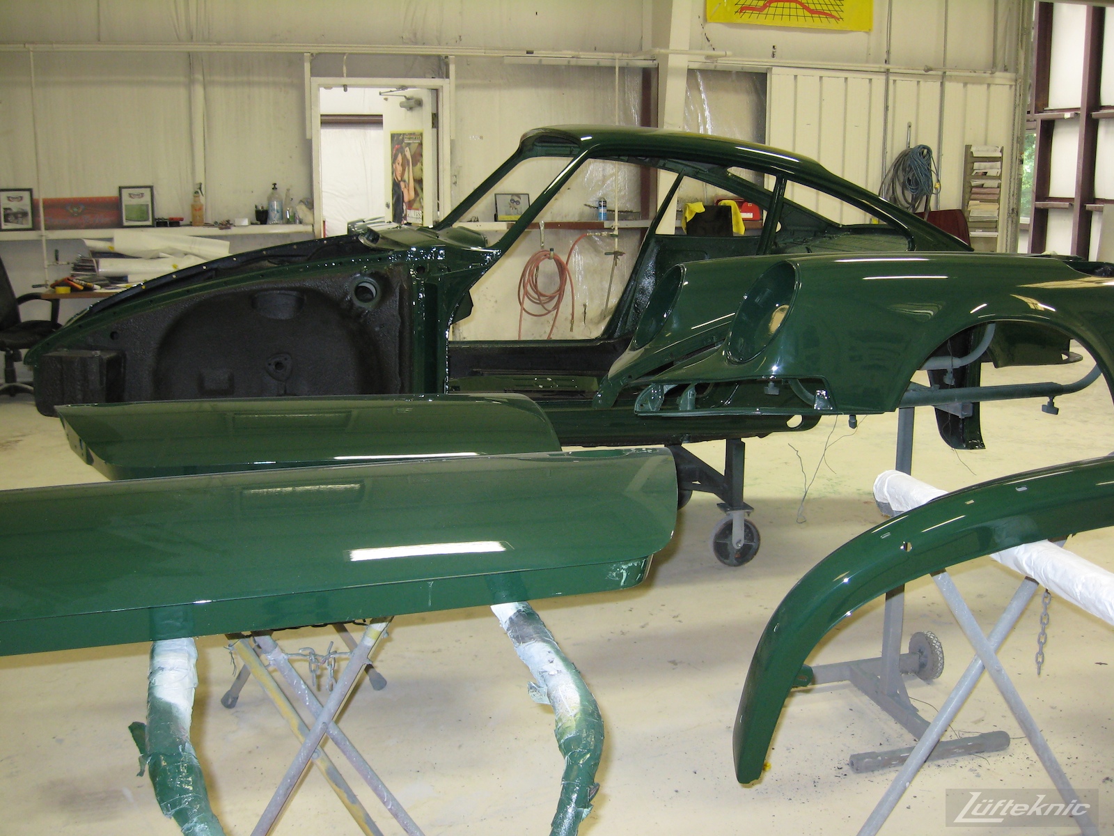 Freshly painted body panels and shell of an Irish Green Porsche 912 undergoing restoration at Lufteknic.
