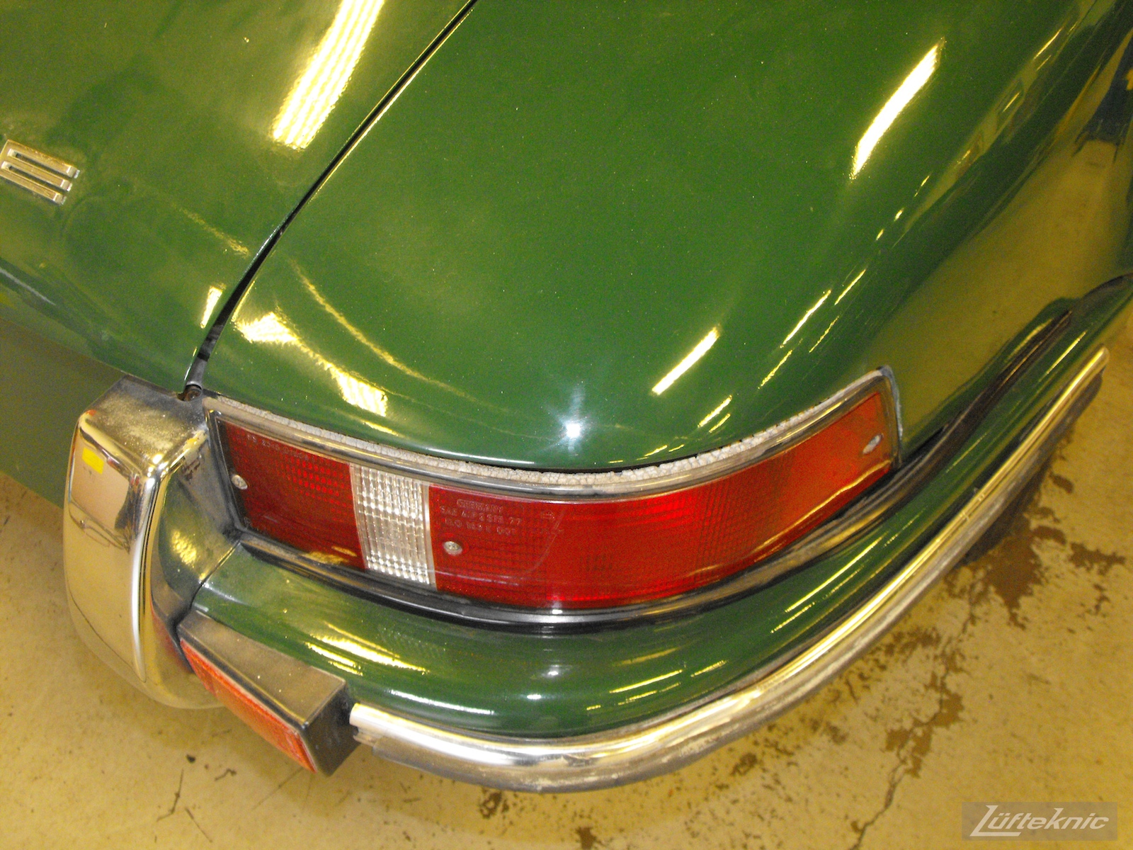 Aged tail lights of an Irish Green Porsche 912 undergoing restoration at Lufteknic.