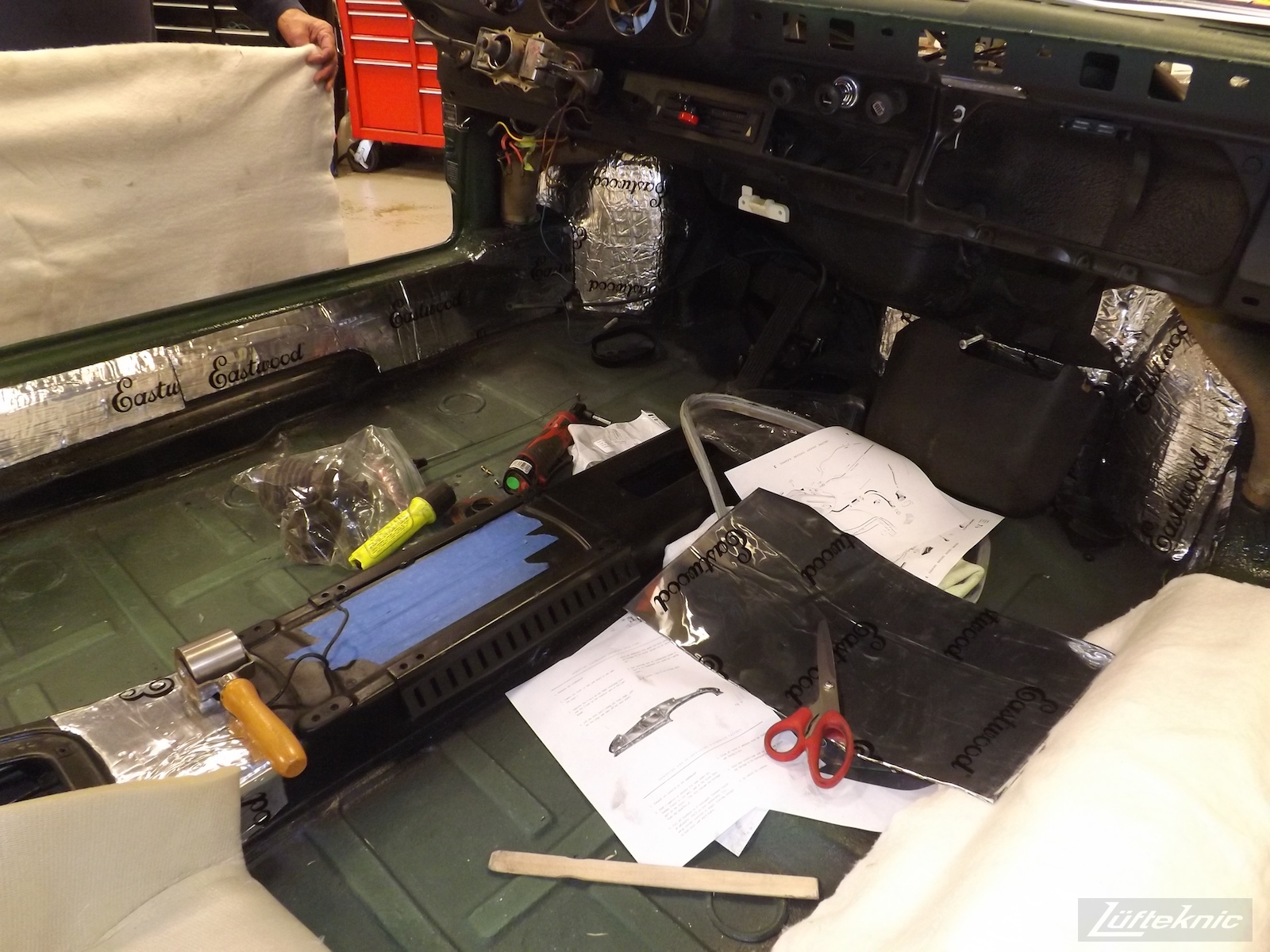 Installing Eastwood sound deadening panels on an Irish Green Porsche 912 undergoing restoration at Lufteknic.