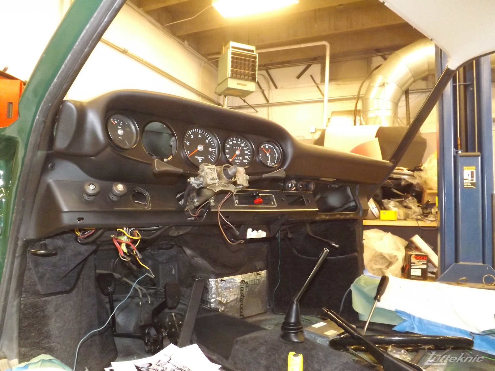 Interior reassembly with dash board and gauges on an Irish Green Porsche 912 undergoing restoration at Lufteknic.