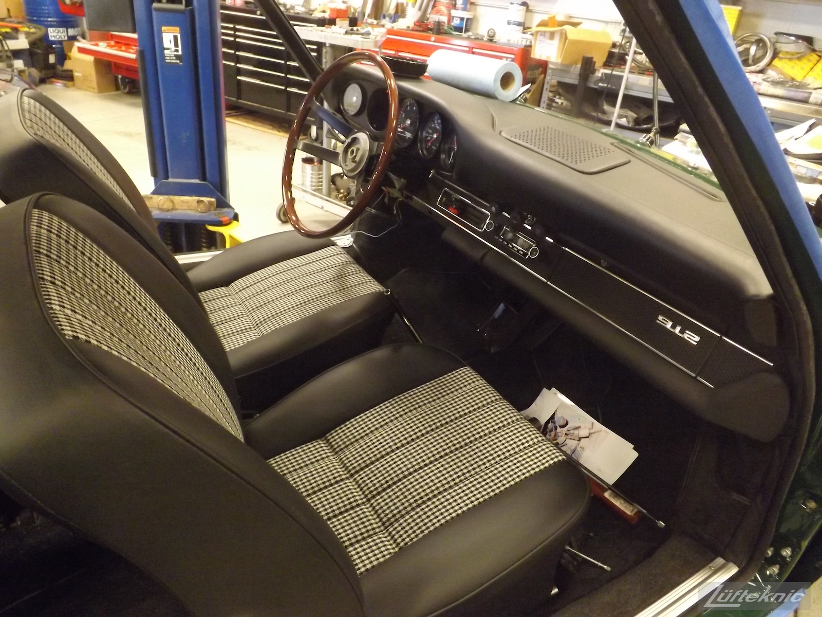 Fresh seats, dashboard and wood rim steering wheel installed in an Irish Green Porsche 912 undergoing restoration at Lufteknic.