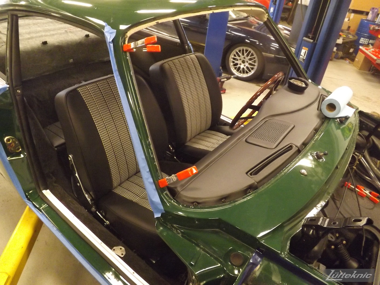Finishing the interior reassembly of an Irish Green Porsche 912 undergoing restoration at Lufteknic.