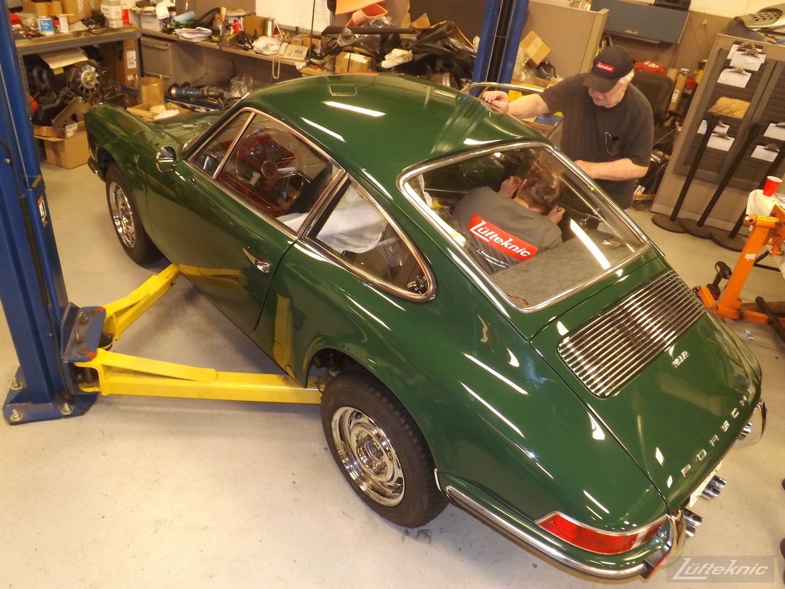 Installing windows into an Irish Green Porsche 912 undergoing restoration at Lufteknic.