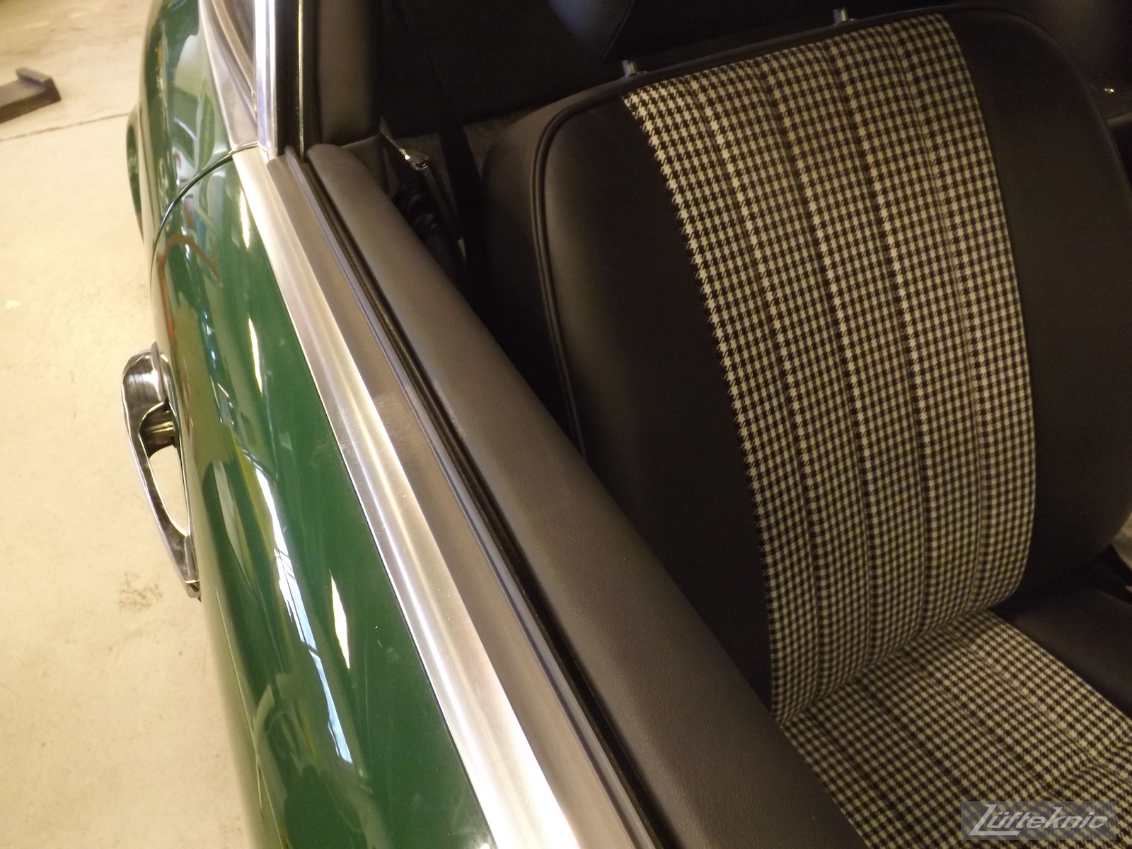 Door and interior details of an Irish Green Porsche 912 undergoing restoration at Lufteknic.