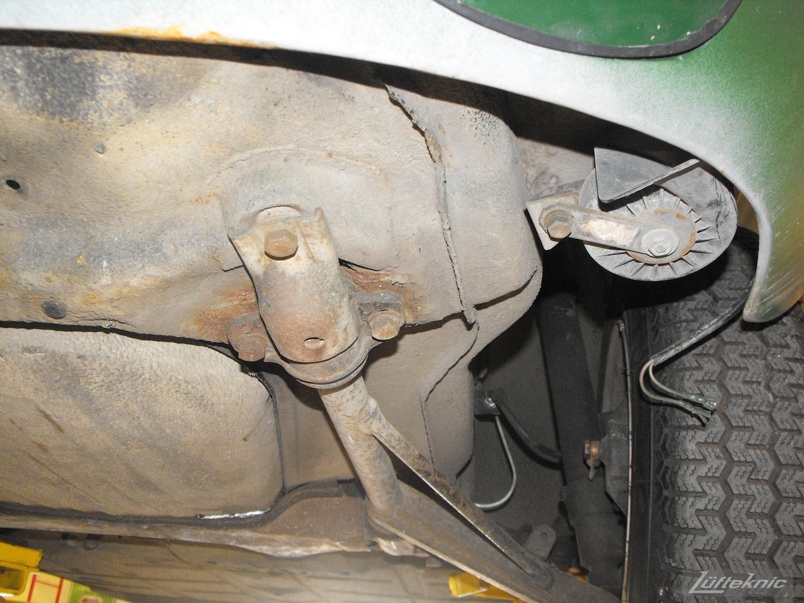 An Irish Green Porsche 912 undergoing restoration at Lufteknic with rust at the front suspension mount on the pan.