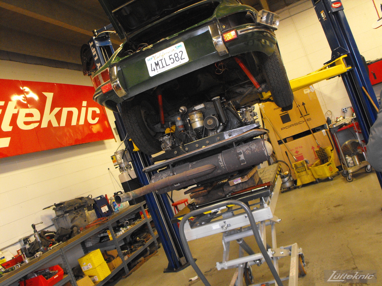 The engine being removed from an Irish Green Porsche 912 undergoing restoration at Lufteknic.