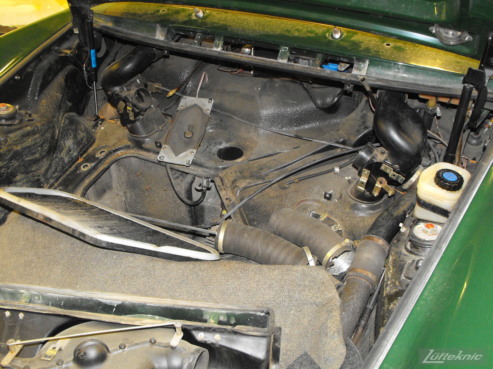 Under the hood of an Irish Green Porsche 912 undergoing restoration at Lufteknic.
