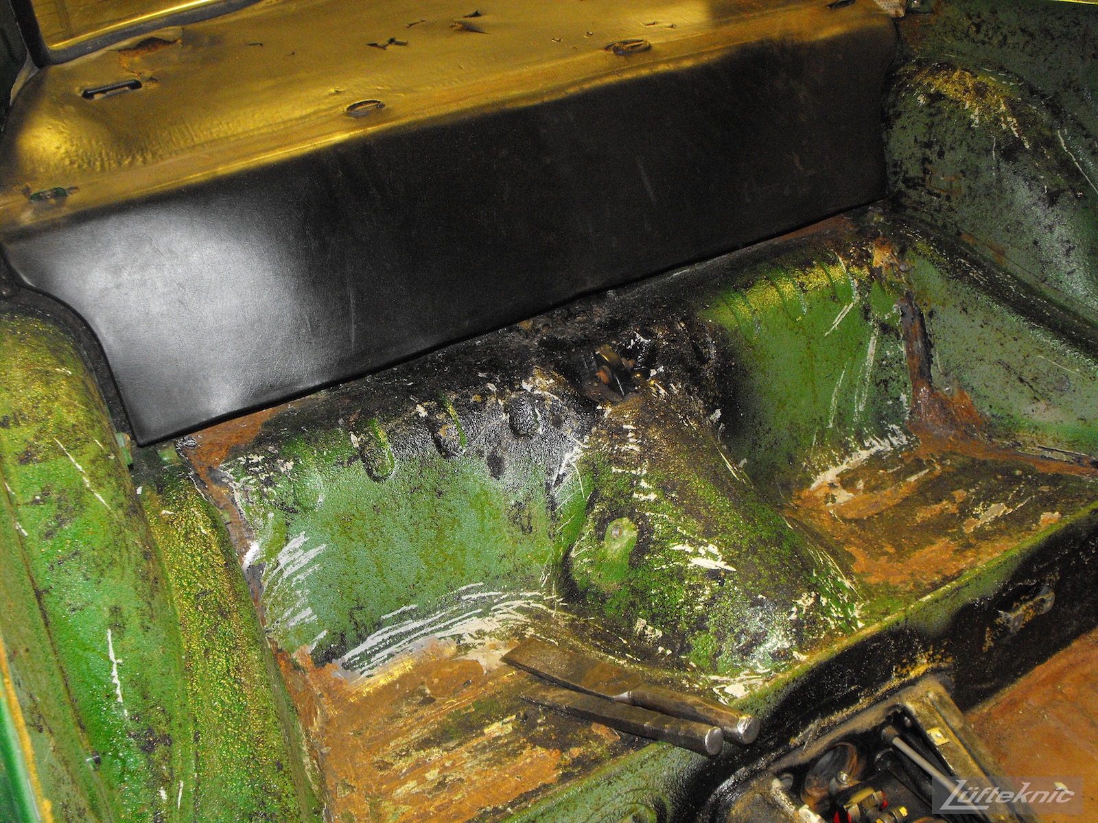Rear seat area with minimal rust on an Irish Green Porsche 912 undergoing restoration at Lufteknic.
