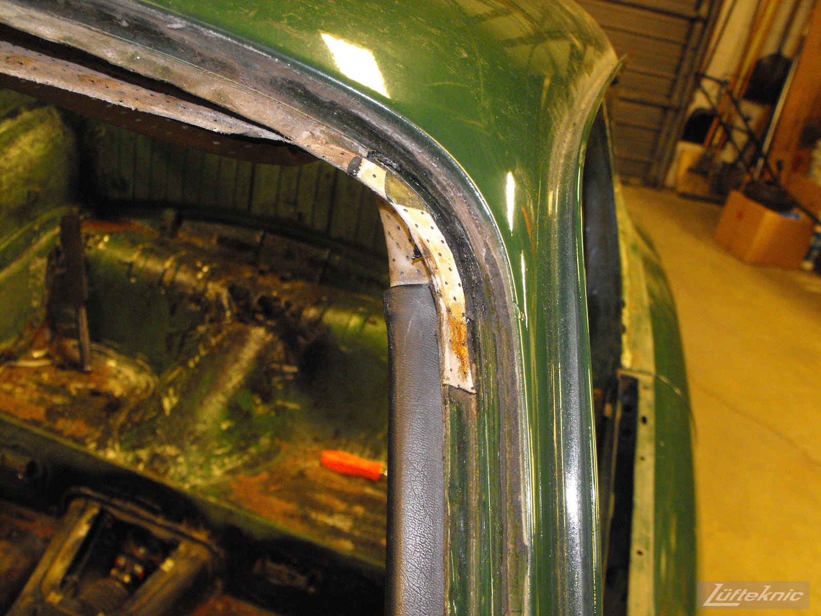Upper headliner detail with the windshield removed on an Irish Green Porsche 912 undergoing restoration at Lufteknic.