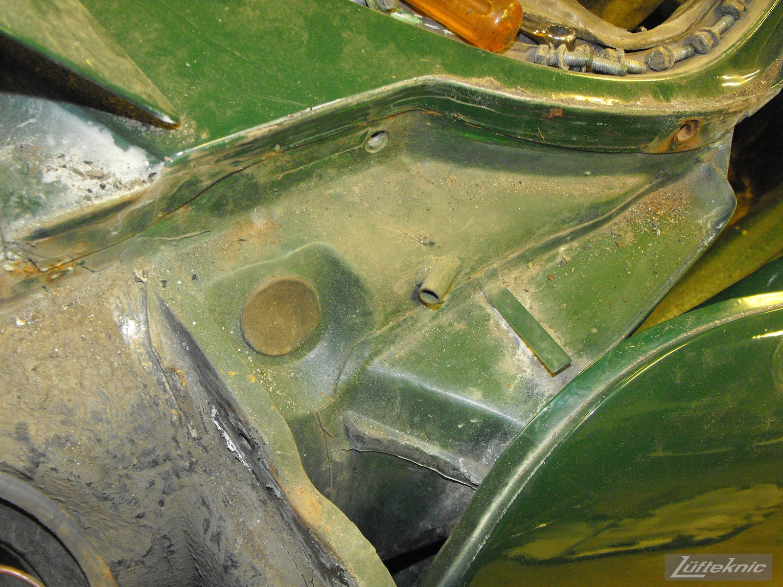 Front chassis detail where the driver's fender mounts on an Irish Green Porsche 912 undergoing restoration at Lufteknic.