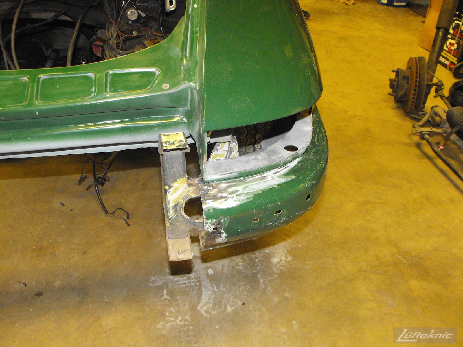Rear bumper repair on an Irish Green Porsche 912 undergoing restoration at Lufteknic.