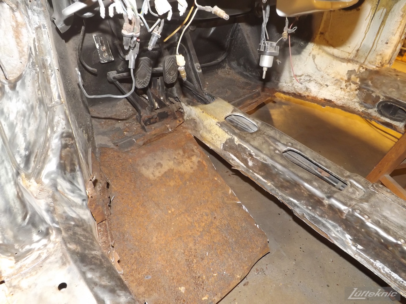 Rust damaged floors being cut away on a 1964 Porsche 356SC restoration.